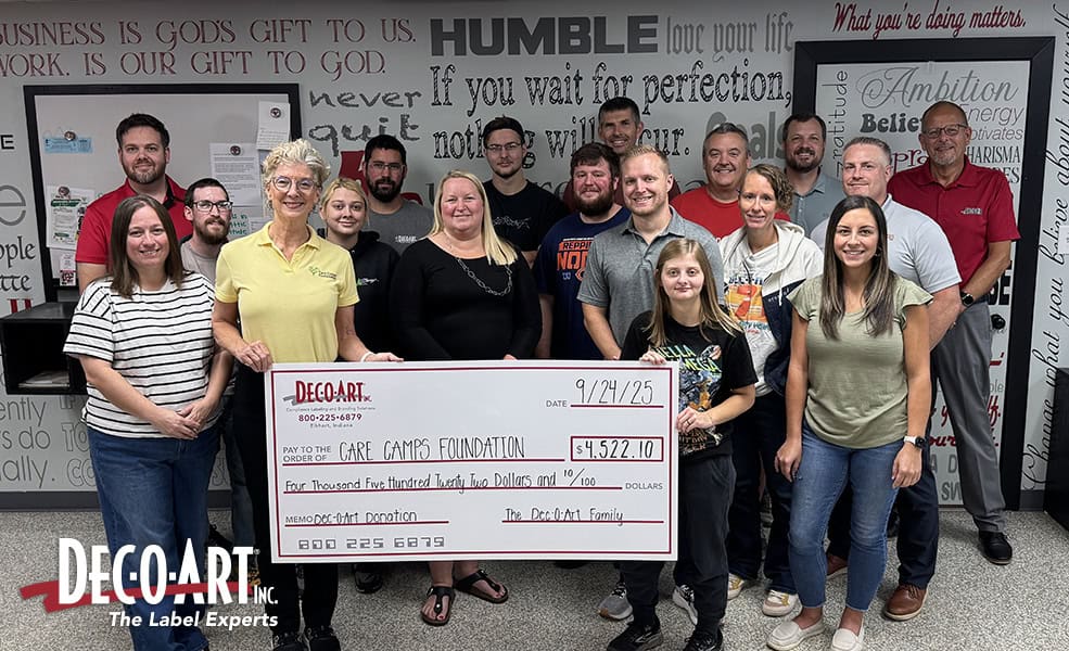 Dec-O-Art presenting a large check to Care Camps Foundation with team surrounding