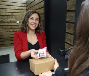 Smiling person holding USA250 label